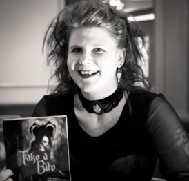 Image of author Nancy Schumann holding a copy of her book Take A Bite. Picture taken by www.soulstealer.co.uk